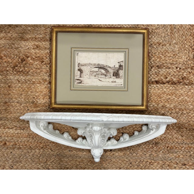 A substantial vintage architectural plaster wall shelf that features a bold central acanthus corbel, scrolling foliate...
