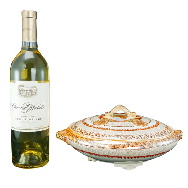 A lightweight ceramic serving dish with matching lid adorned with intricate and colorful transfers of chrysanthemums and...