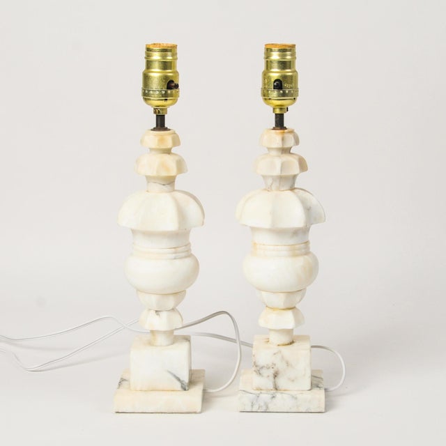 Vintage matching pair of small carved alabaster table lamps with unique shape. This hard to find lamp pair will look great...