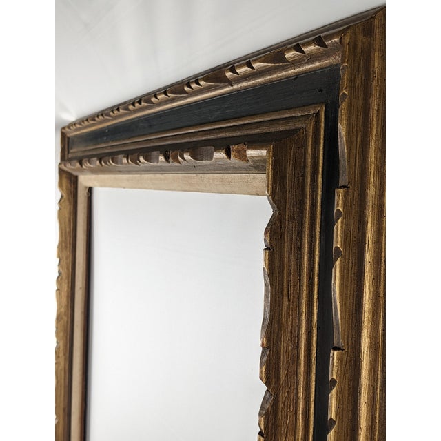 A handsome large-scale vintage wood picture frame featuring a richly layered gold and deep blue finish with carved...