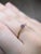 A purple sapphire sits in a rich royal purple at the centre of this solid 14K yellow gold ring, surrounded by four earth-...