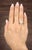 A captivating GIA-certified 0.74-carat cushion-cut yellow diamond commands attention, showcasing a VS2 clarity. Encircling...