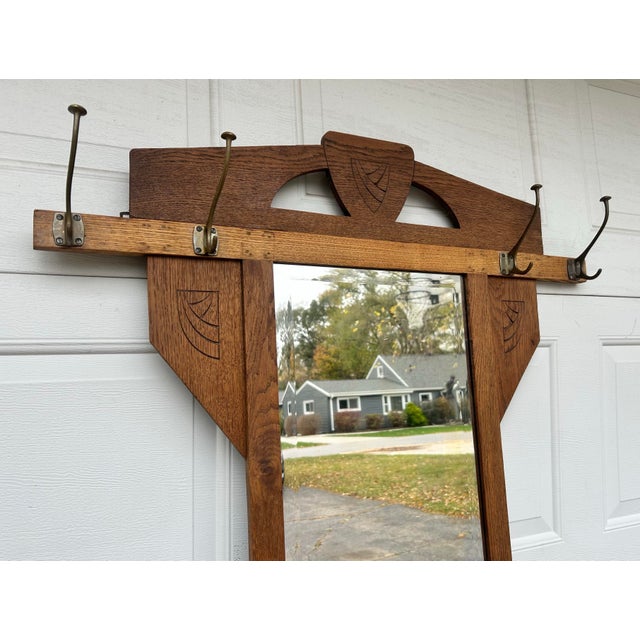 Vintage, tall carved hall tree, with vertical mirror and small wooden lidded compartment for storage. A nice, understated...