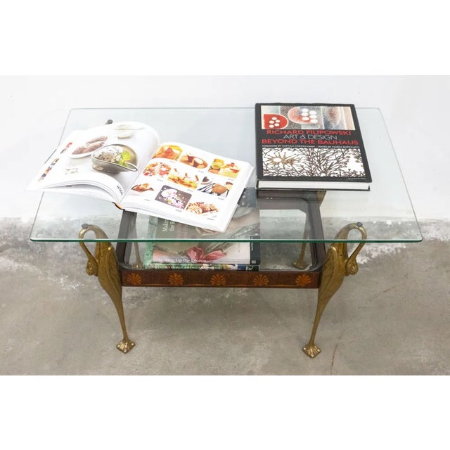 Early 1900s wooden coffee table decorated with walnut and maple inlays The 4 legs, depicting swans, are made of brass Two...