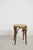 Vintage bentwood stool featuring a natural cane seat and steam-bent wooden frame in the classic Thonet style. One...