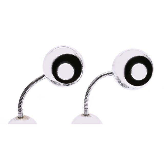 A visually striking pair of vintage desk lamps in polished chromium-plated metal, designed in the Space Age style of the...