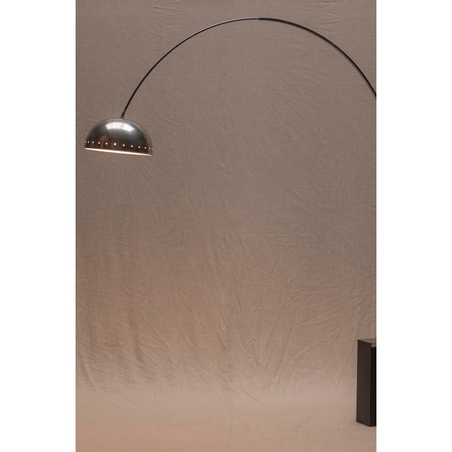 A timeless Space Age arc floor lamp from the 1970s, defined by its thin, elegant silhouette and beautifully subtle curved...