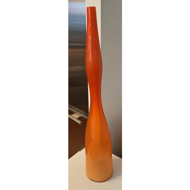 1970's orange glass vase. Orange glass has tones of orange and gold.
