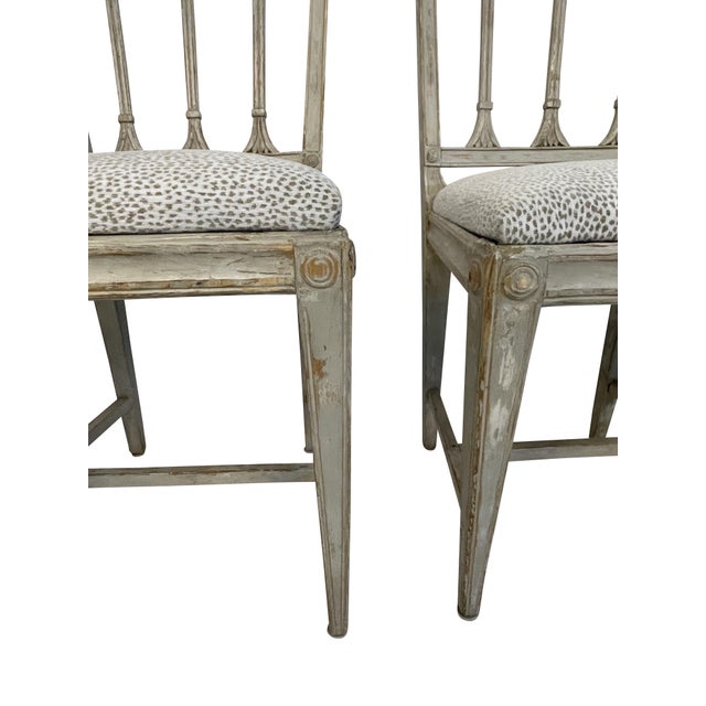 A four-chair set of period Neoclassical Swedish chairs with new light grey animal print upholstery. Straight clean lines...