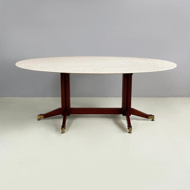 Italian mid-century modern Dining table in mrble, wood and brass, 1960s Dining table with oval top in light marble, in...