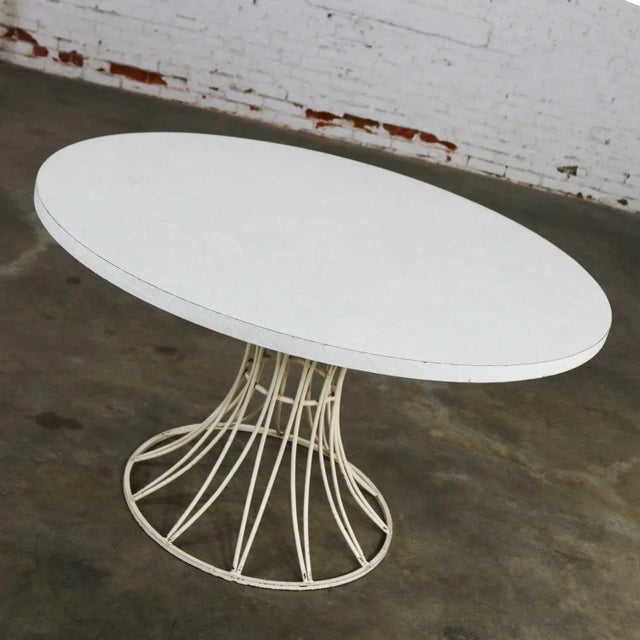 Wonderful mid-century modern round white wrought iron patio table base with white slate-like textured laminate top by Max...
