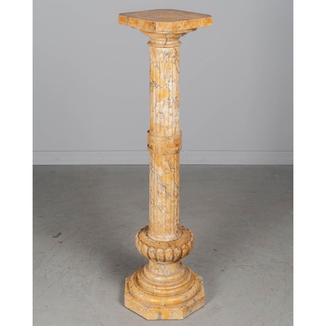 An early 20th century Italian Neoclassical style column pedestal, hand-carved from highly figured yellow toned alabaster...