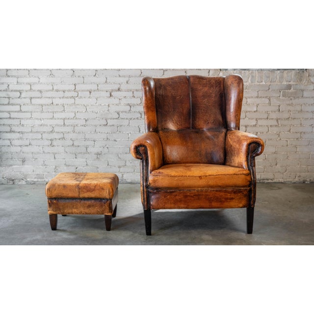 1970s Vintage Art Deco Distressed Cognac Leather Wingback Chair & Ottoman For Sale - Image 4 of 16