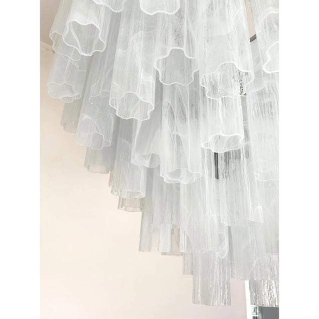 Contemporary italian chandelier with transparent venied-white “tronchi ” murano glass . this round chandelier showcases a...
