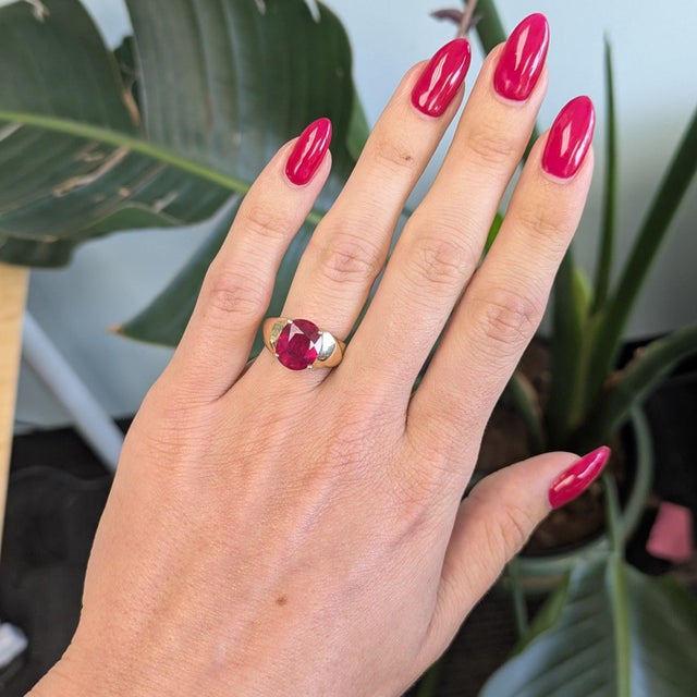 A generous 5.82-carat Madagascar ruby glows in a deep, warm red at the centre of this solid 14K yellow gold estate ring....