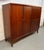 Beautiful vintage Danish Mid-Century Modern highboy gentleman’s wardrobe crafted in richly figured teak, showcasing the...