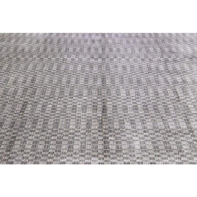This exquisite contemporary wool and silk rug showcases a striking gray-silver base adorned with a stunning geometric...