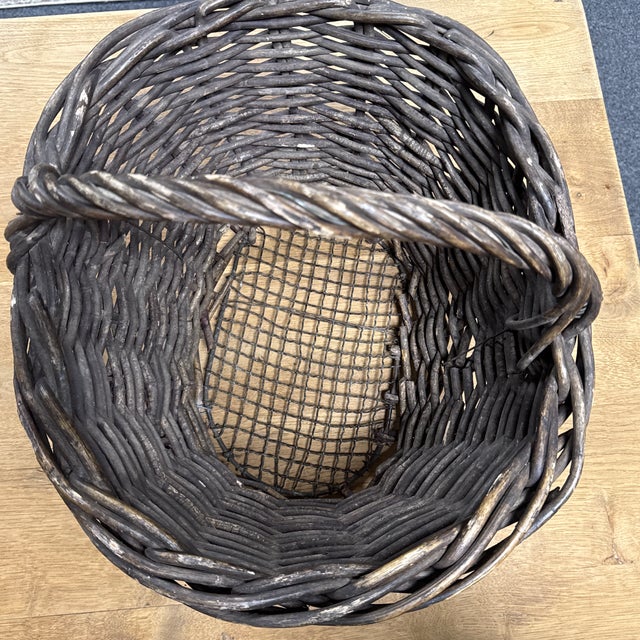 This vintage French basket is a testament to exquisite craftsmanship. Beautifully woven with intricate detail, it boasts a...