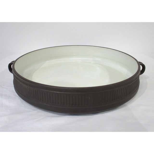 A nice sized paella, casserole or baking dish with matching lid manufactured by Dansk from their Flamestone collection...