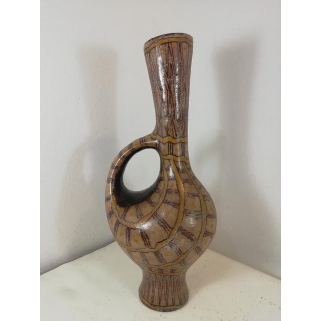 Beautiful vase in the shape of a spout in glazed ceramic and metallic lustres. Produced by the Carlo Zauli factory called...