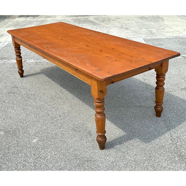 This exceptional vintage farm table seamlessly bridges the gap between rustic charm and industrial utility. Crafted with a...