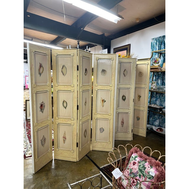 A sophisticated matching pair of 1980s four-panel folding screens with timeless Neoclassical styling. Hand-painted on both...