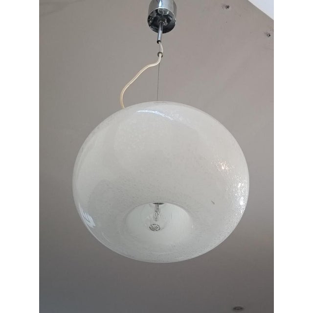 Magnificent pendant lamp by Mazzega. Italy, 1970s. Chrome-plated metal frame. It supports a large Murano blown glass...