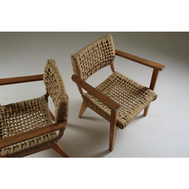 Pair of bridge armchairs by the french adrien audoux and frida minet and dating from the 1950s. The structure is in beech...