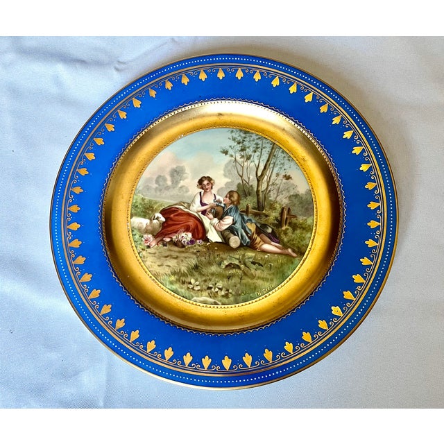 An exquisite and finely detailed antique Royal Vienna porcelain cabinet plate, beautifully hand-painted by the highly...