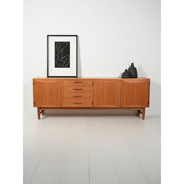 Scandinavian teak sideboard produced by "Ajfa Möbelfabrik" in Tibro, with a strong sculptural character and elegant...