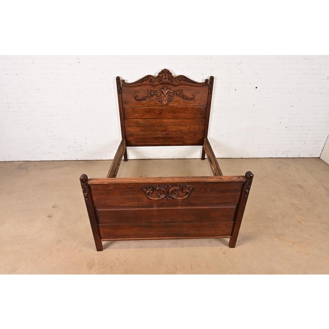 A gorgeous antique Victorian carved oak full size bed frame USA, Circa 1890s Measures: 56.75"W x 77.5"D x 60.25"H. Very...
