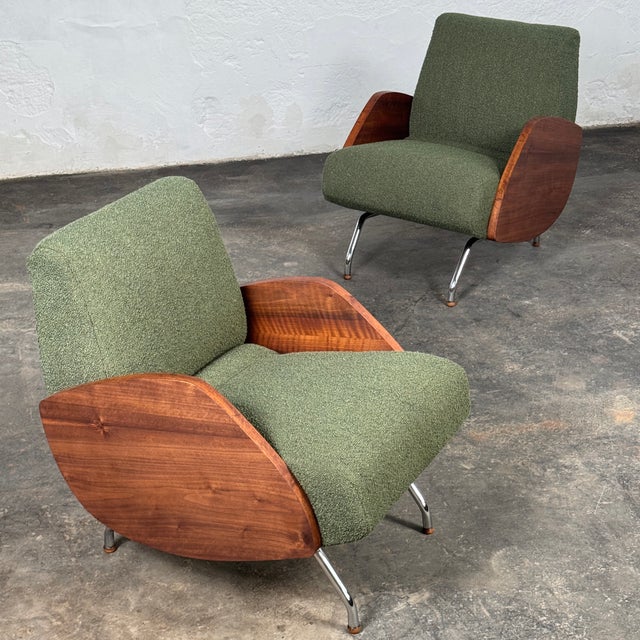 This striking pair of mid-century modern lounge chairs is a masterpiece of polish modernist design, created by the...