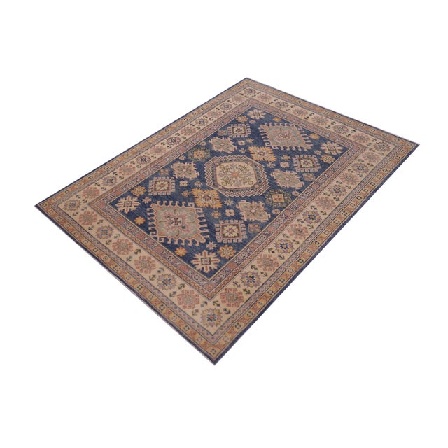 Enhance your home with this exquisite hand-knotted Kazak rug, crafted from fine hand-spun wool and dyed with all-natural...