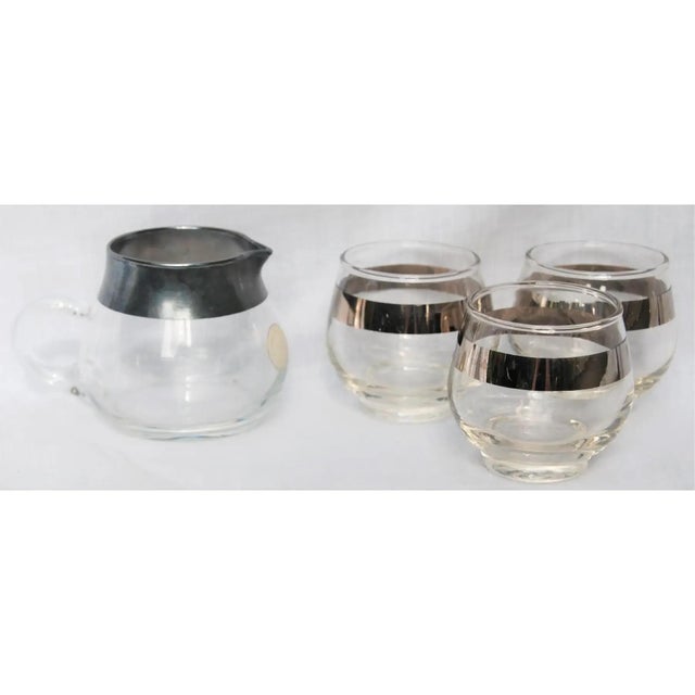 Beautiful Dorothy Thorpe set of a creamer and three roly poly glasses. The creamer still has the original sticker on it....
