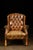 This wingback tufted chair features leather and wooden construction.