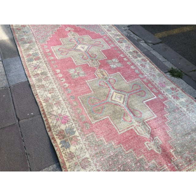 This is a vintage Turkish Oushak rug from the 1960s. The piece was hand-knotted.