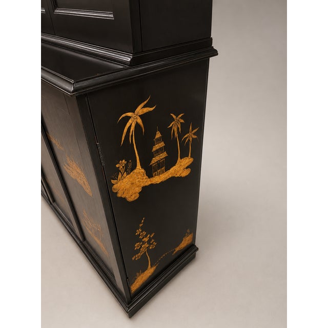 A monumental 19th century black painted cabinet of impressive architectural scale, later decorated with richly raised...