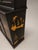 A monumental 19th century black painted cabinet of impressive architectural scale, later decorated with richly raised...