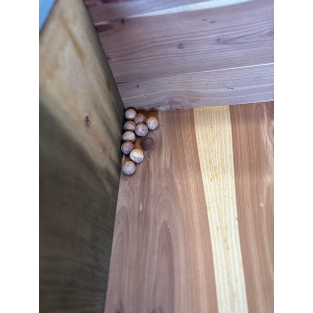 Striking French-inspired dresser finished in a rich matte black, contrasted with beautifully figured burled wood drawer...