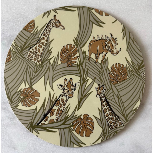 Set of vintage placemats with safari motif with giraffes and other Kenyan wildlife housed in a decorative storage box....