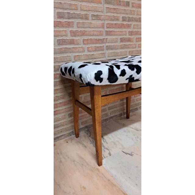 A vintage or Nordic-style stool or footstool, characterized by a low beechwood frame and striking quilted fabric mimicking...