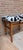 A vintage or Nordic-style stool or footstool, characterized by a low beechwood frame and striking quilted fabric mimicking...