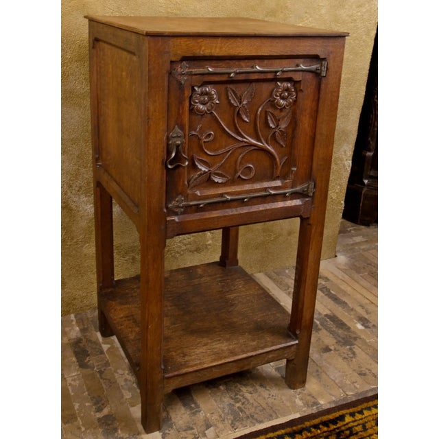 Hand-carved neo-Gothic table made of solid oak wood, dating from the 19th century. The front door is decorated with rich...