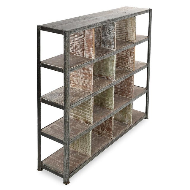 This shelf on iron and solid wood legs combines robustness and industrial elegance. Equipped with 16 compartments, it...