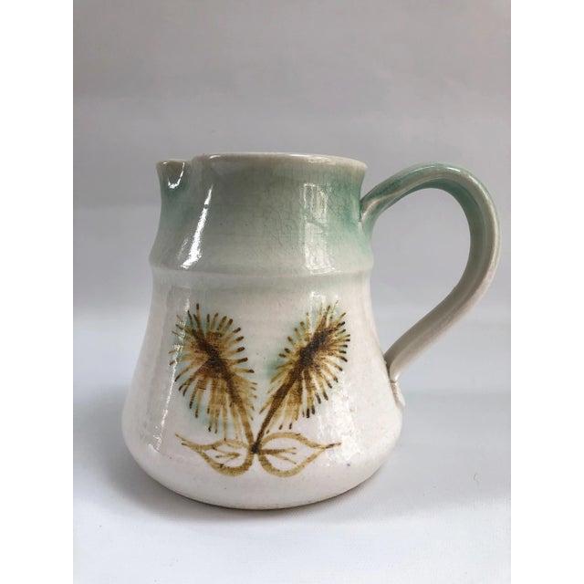 Midcentury Studio pottery hand-decorated pitcher in excellent condition. Maker's mark on underside.