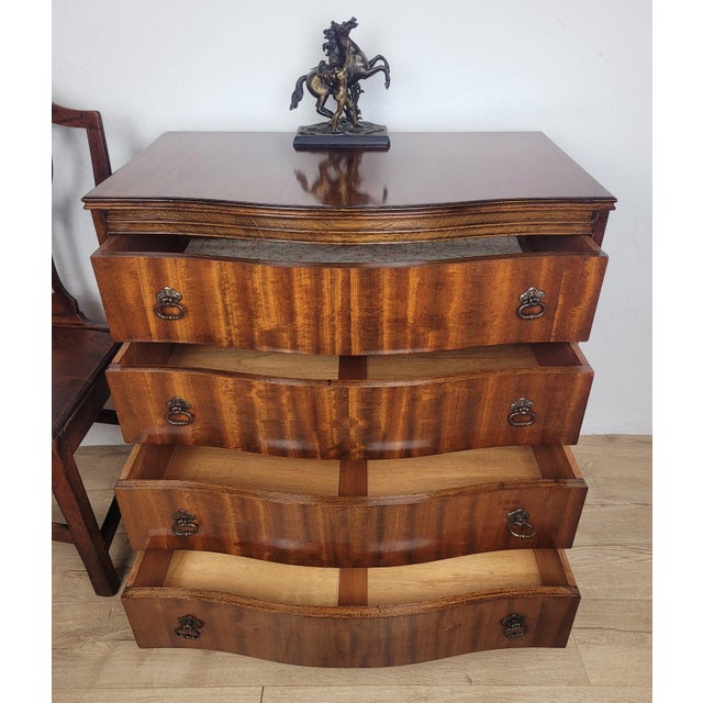 This is a gorgeous antique serpentine chest of drawers, displaying a rich mahogany patination to the front that is sure to...