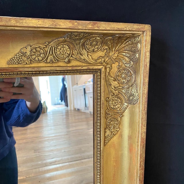 Refined 19th century French antique Gilt Empire mirror with applied decorative motif gilt work on a rectangular frame,...