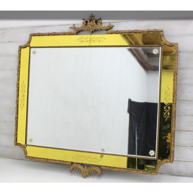 An Italian giltwood wall mirror with a canary‑yellow glass border, in the Rococo Revival style, circa mid‑20th century,...