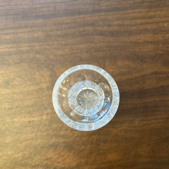 Small crystal vase with intricate carvings.