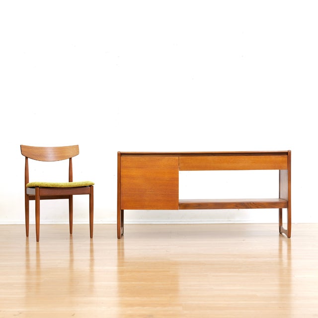 This vintage media cabinet was produced in England during the 1960s. It is able to house 12" vinyl records behind the...